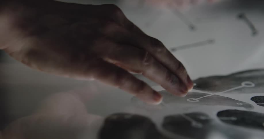 A person is looking at templates on sheets of paper