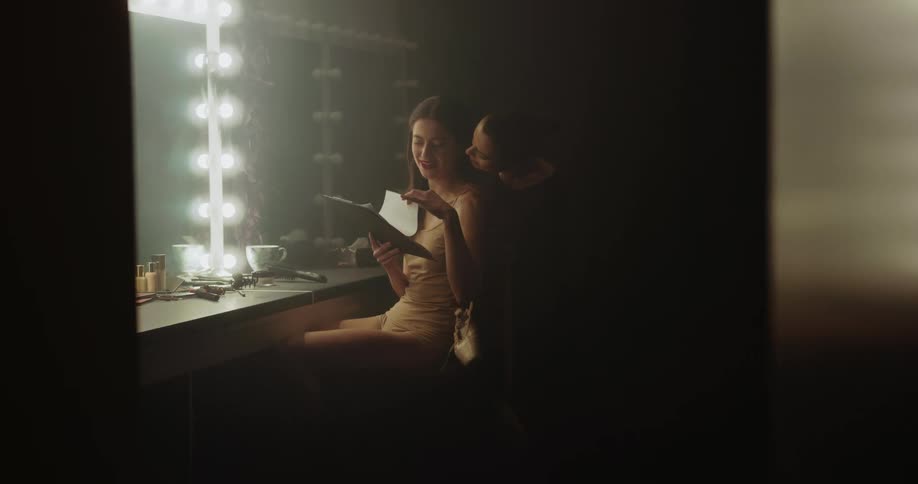 Two friends are talking together in a room