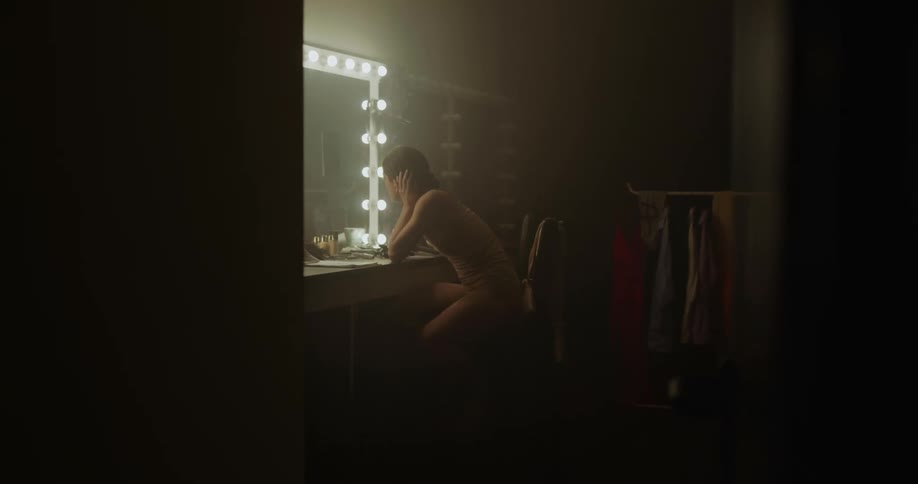 Angry and sad female dancer rushes to the dressing room