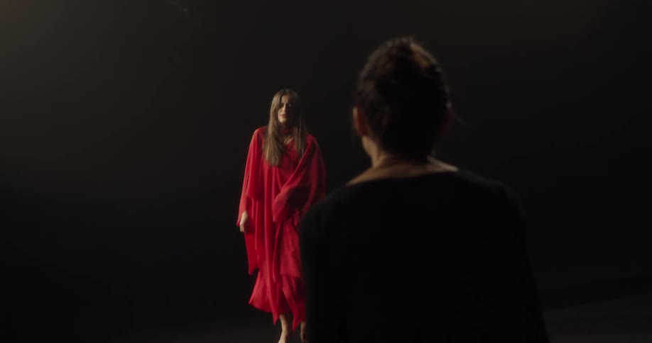 Two women are dancing on stage in a room
