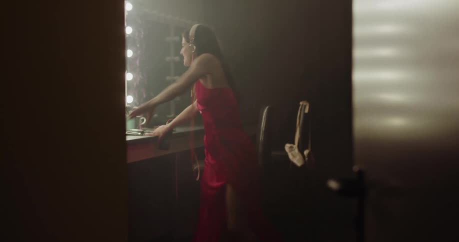 A woman is dancing in the dressing room