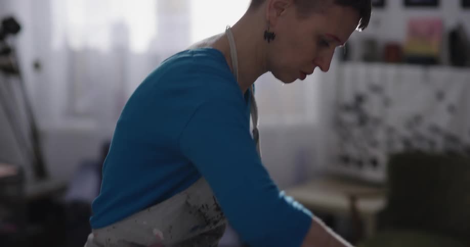 Two women are in a room and painting a picture