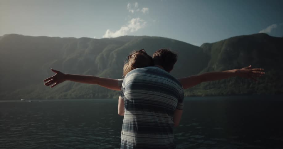 Two people are standing outdoors and looking at the horizon