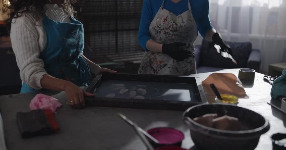 Two women are painting in a room together