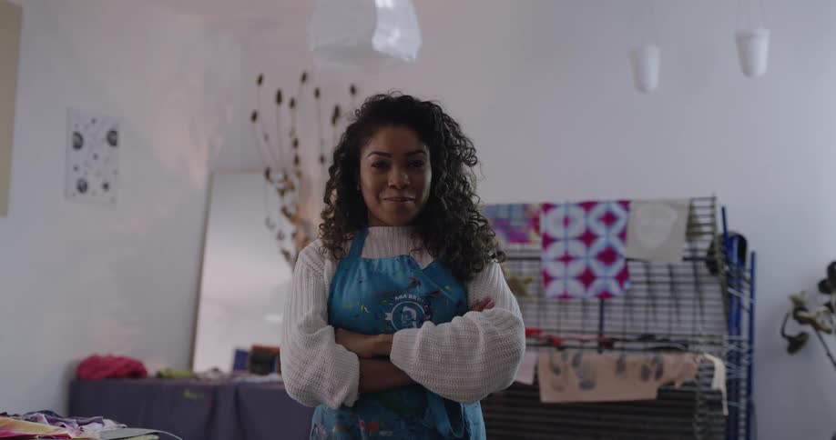 A woman is standing in a room and smiling