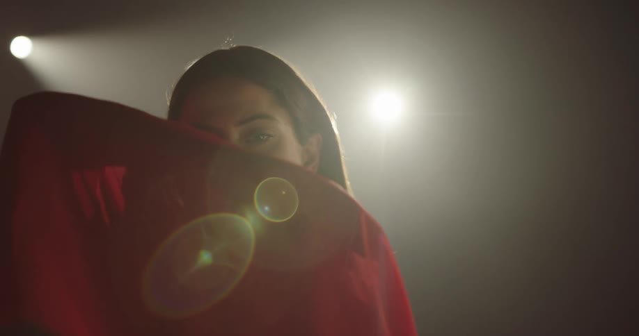 A woman is dancing on a stage indoors