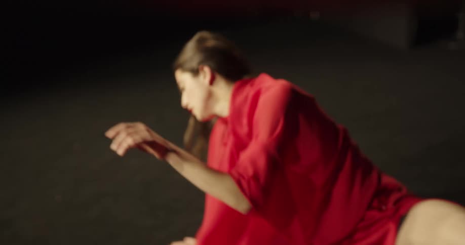 A female dancer with long blonde hair is performing ballet wearing a flowing outfit