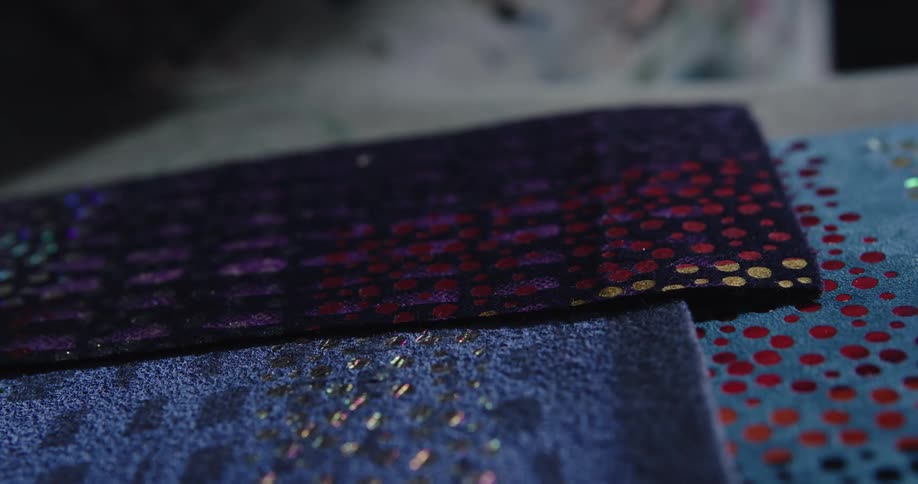 A person is feeling different types of fabric