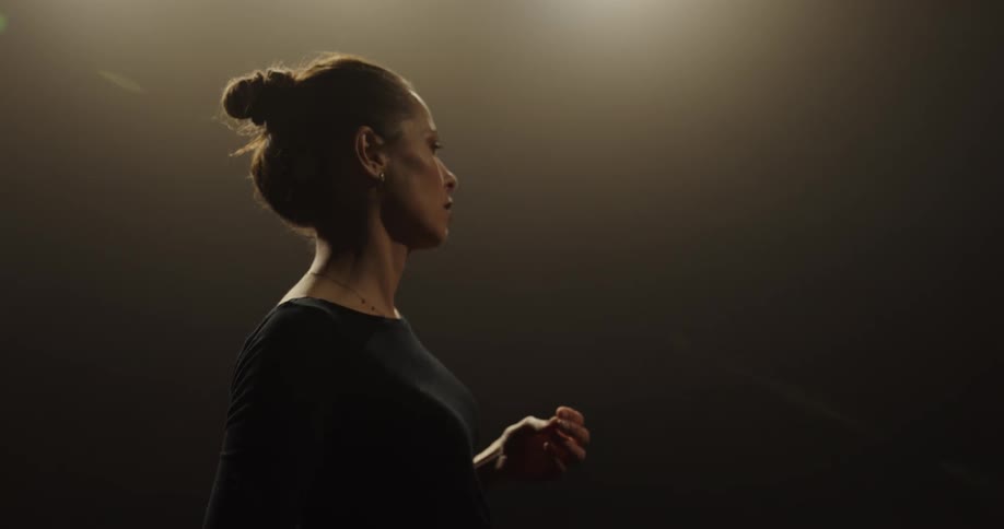 A woman is dancing while a different woman is choreographing the dance