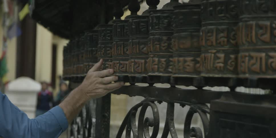 A person drags their hands over engraved objects turning them