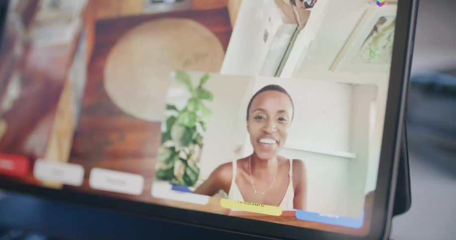A woman is waving on the computer screen