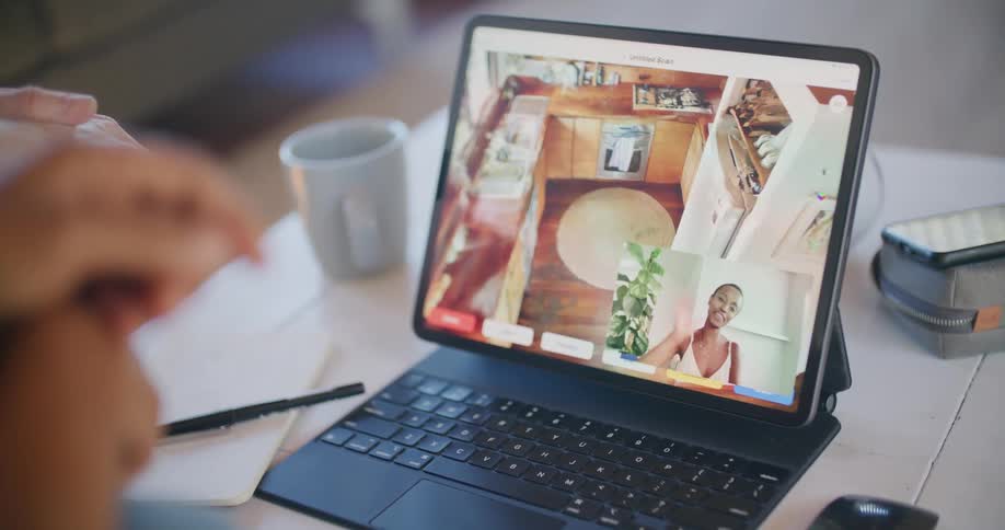 A person is talking to someone on a video chat on a laptop sitting on a desk