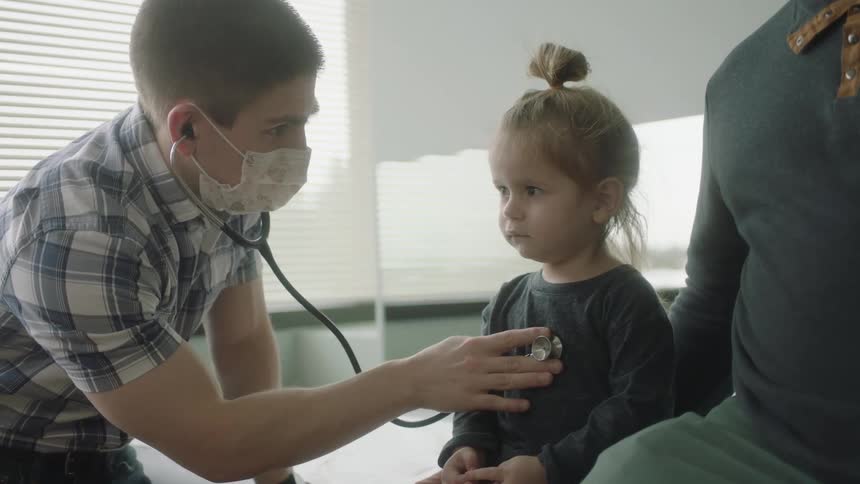 Man checking childs heartbeat
