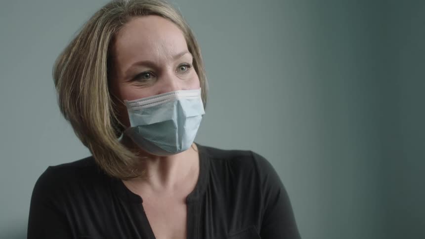 Woman talks while wearing a medical mask
