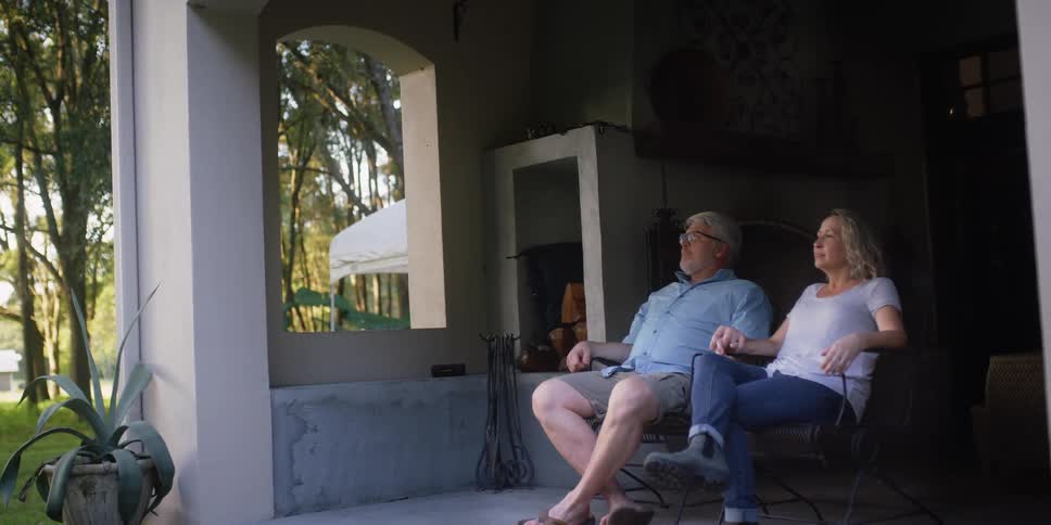 Man and woman are sitting outdoors on their patio in spring