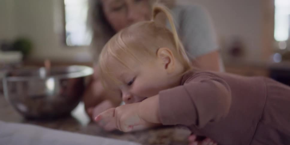 A mother and daughter baking in a kitchen