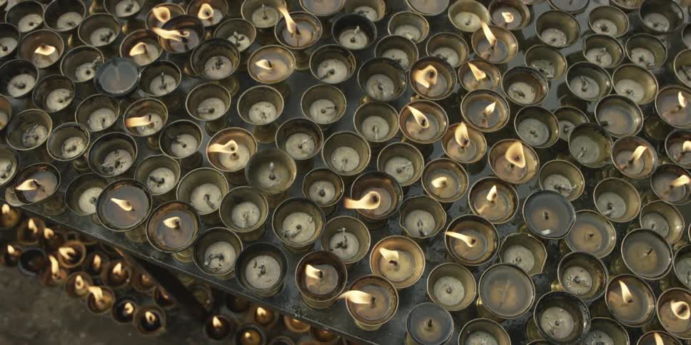 A large area is full of lit candles