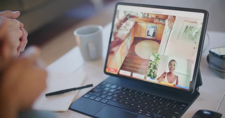 Man and woman make a video call and look at kitchen design on an iPad