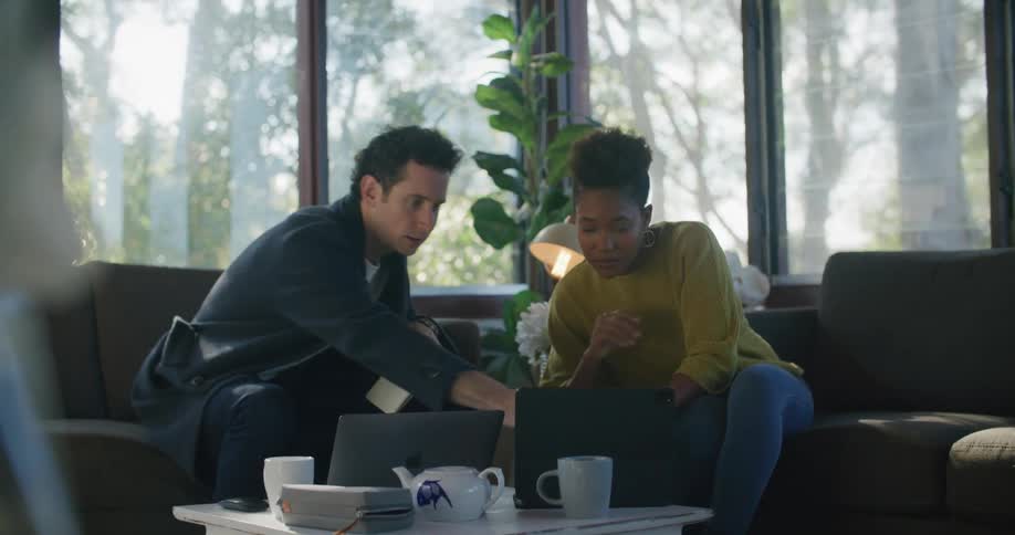 A man and woman looking at items on a computer