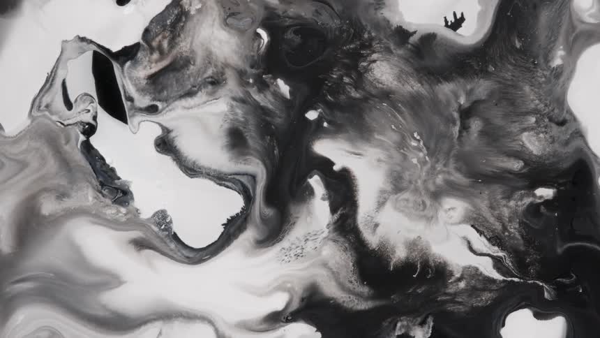 Black and white paint swirls and flows