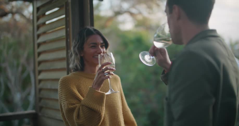 A man and woman drinking wine outdoors