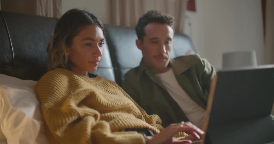 Female and male lying on couch