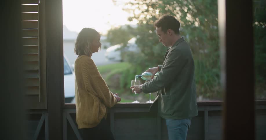 A man and woman having wine outdoors