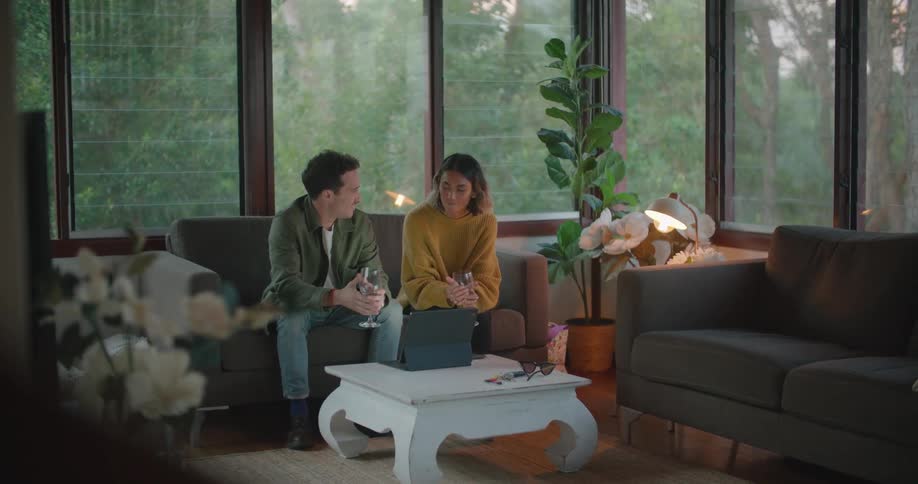 A man and woman are sitting on a couch and talking