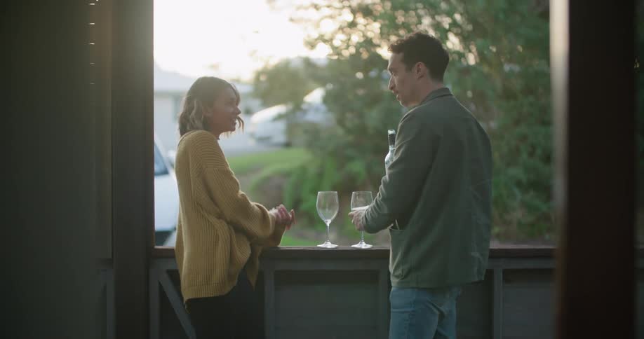 A man and woman drinking wine outdoors