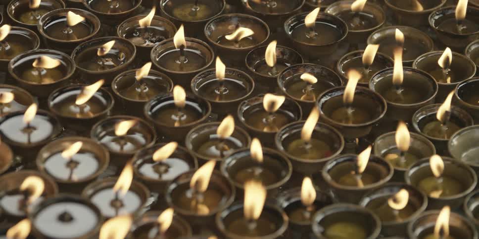 Close up of a row of lit candles