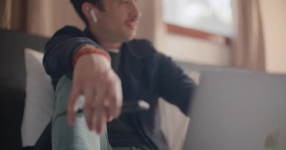 A man is talking on the laptop at home