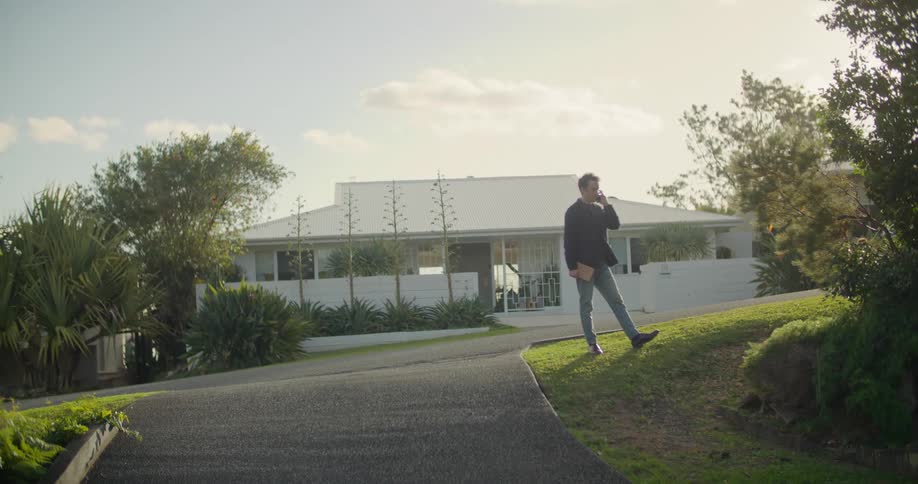 A man standing outdoors talking on a phone