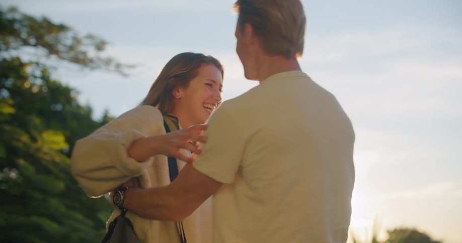 A man and woman hugging and laughing
