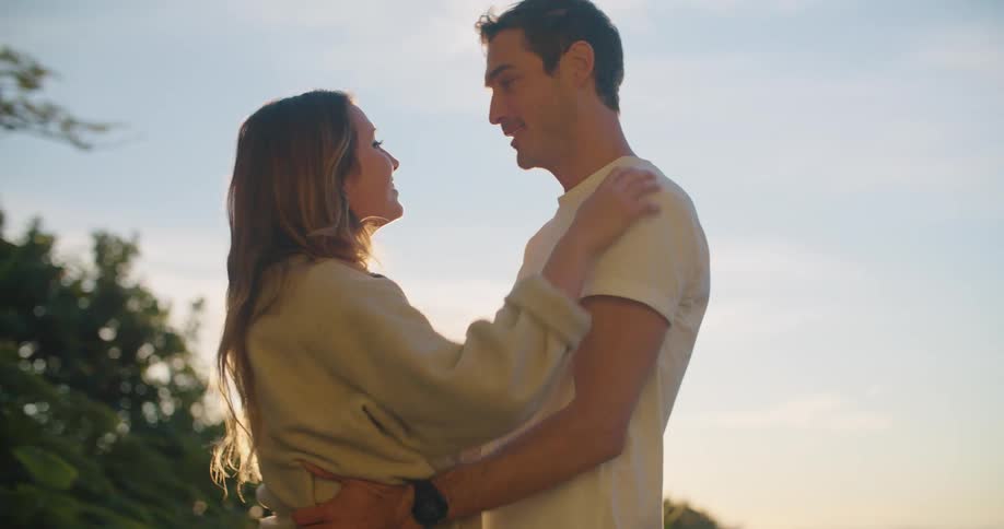 A couple hug and talk outside