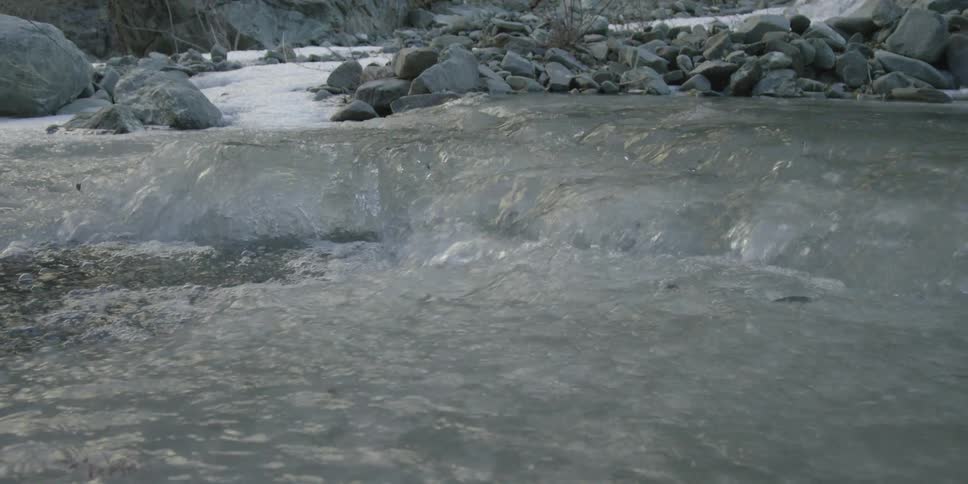 A rushing stream pouring into a bubbling pool
