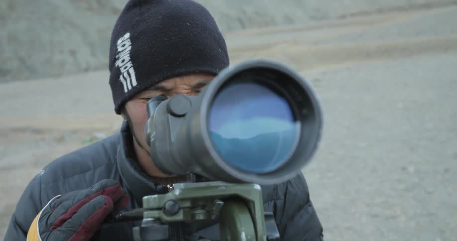 A man uses a wide lens to take take photographs
