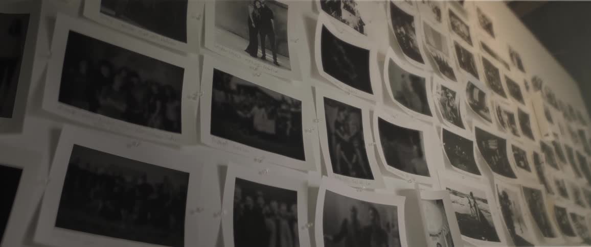 Black and white photo prints fill white wall