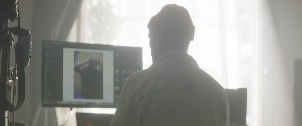 A man is looking at photos on the computer
