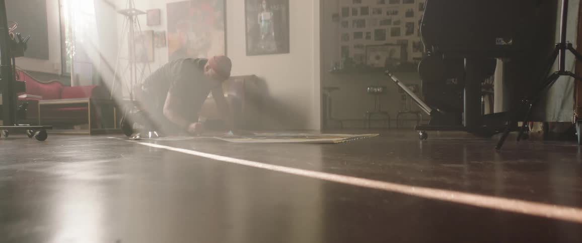 A man is cleaning the ground in a house