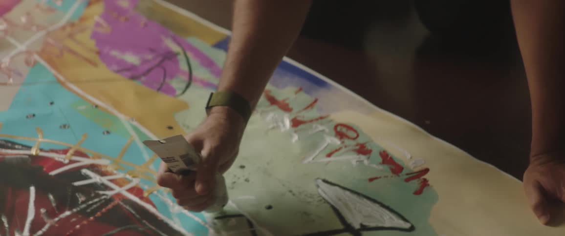A painter painting on a canvas