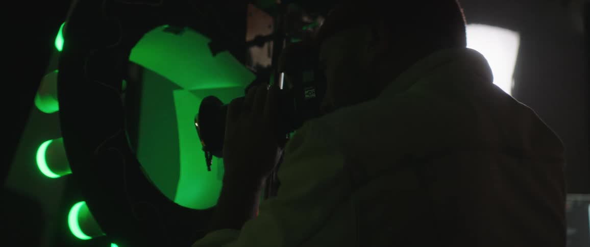 A man is taking pictures with a camera indoors
