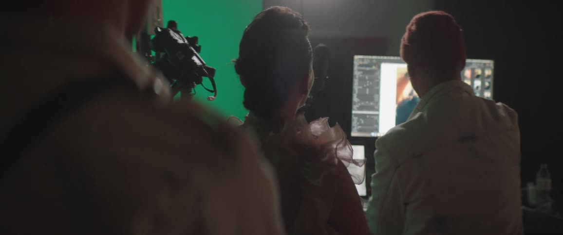 A group of people reviewing photos taken by a photographer