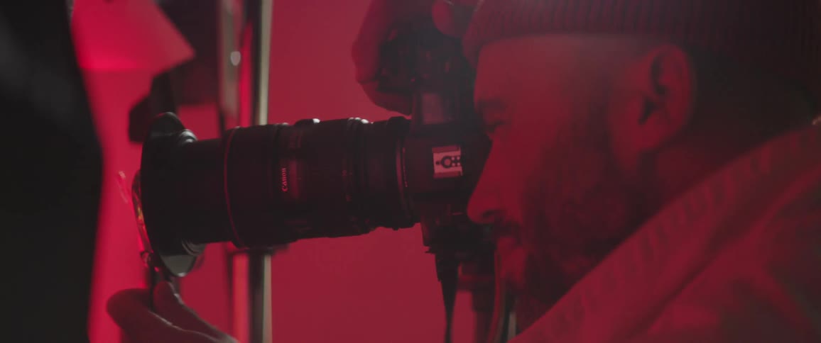 A man is in a room and taking pictures with a camera