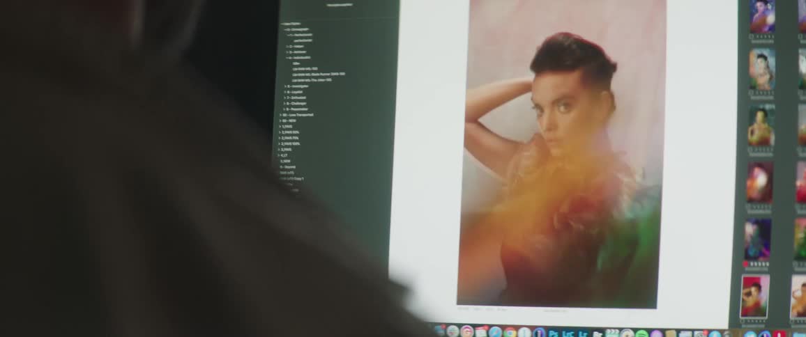 Man photoshops womans background photo on desktop in the studio
