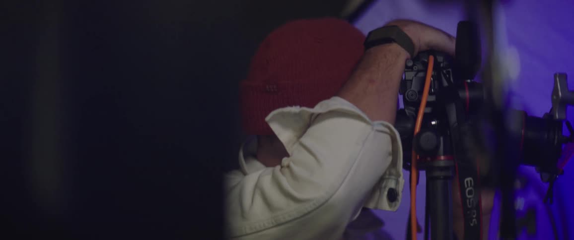 A photography with his face close up a camera taking pictures at a photoshoot