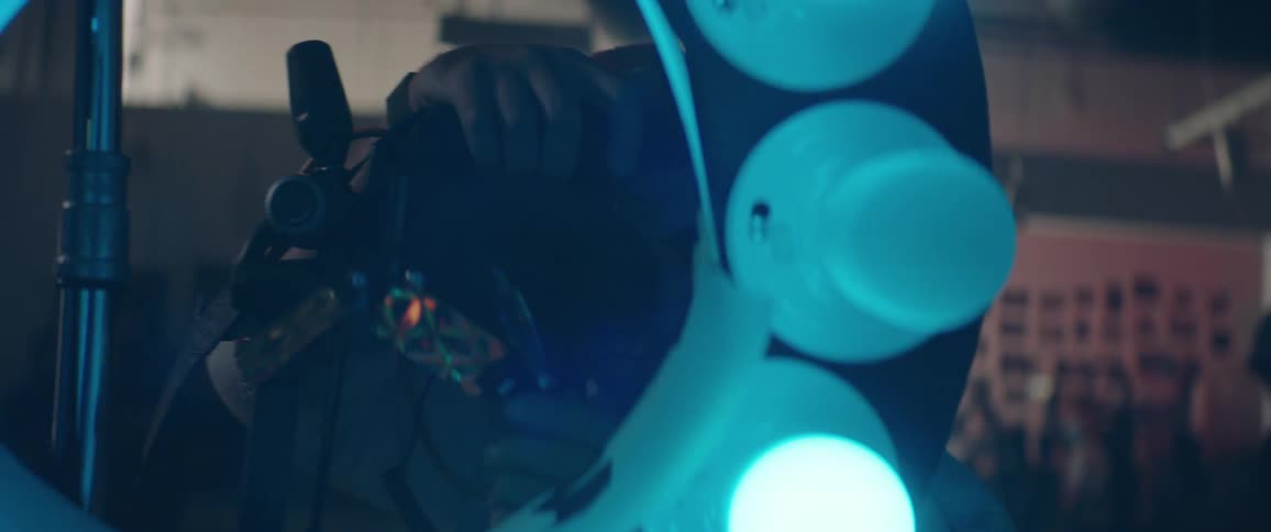 Photographer studios setting before taking pictures through center of circle of colored lights