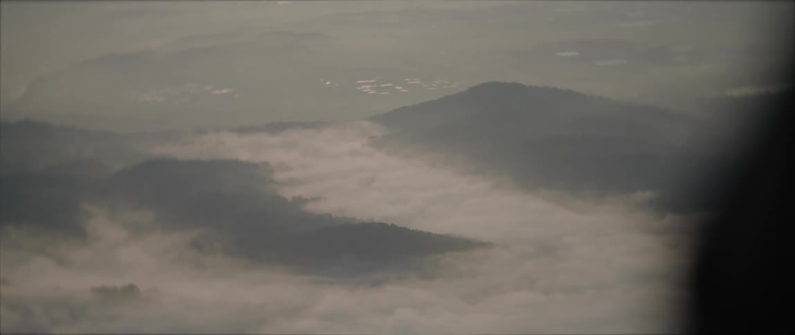 Clouds and heavy fog obscure mountain and valley