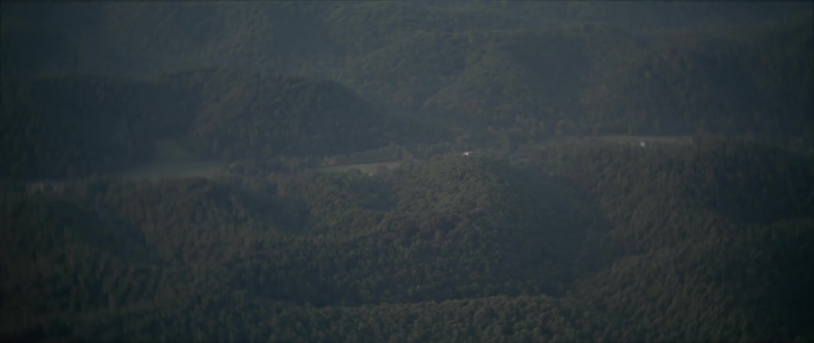 Fog covers the hills below