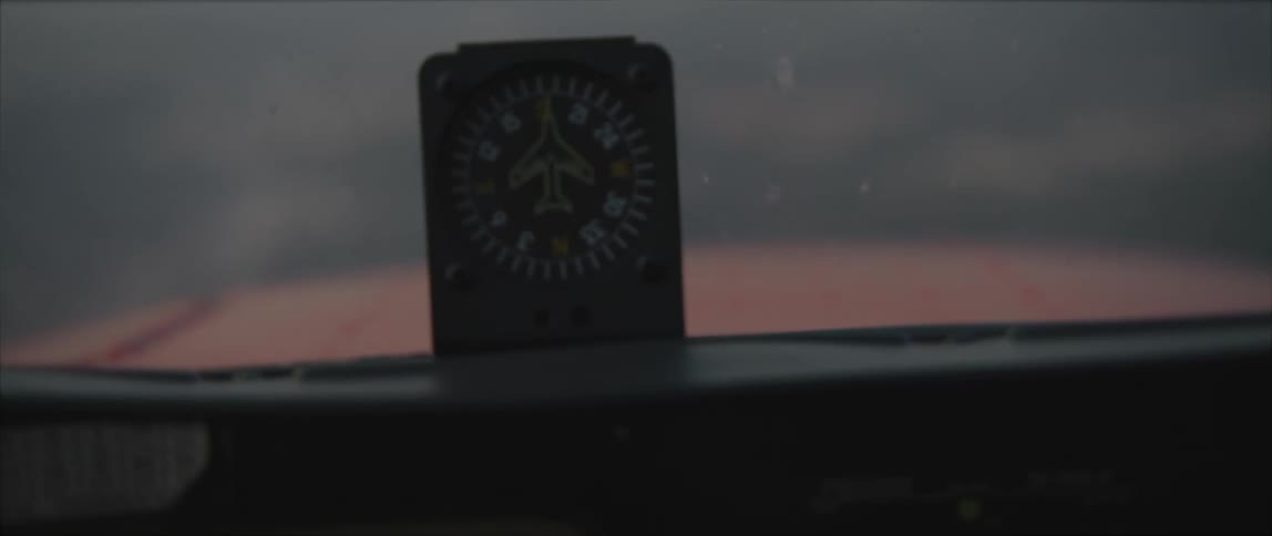 An aircraft flying with a compass next to the windshield