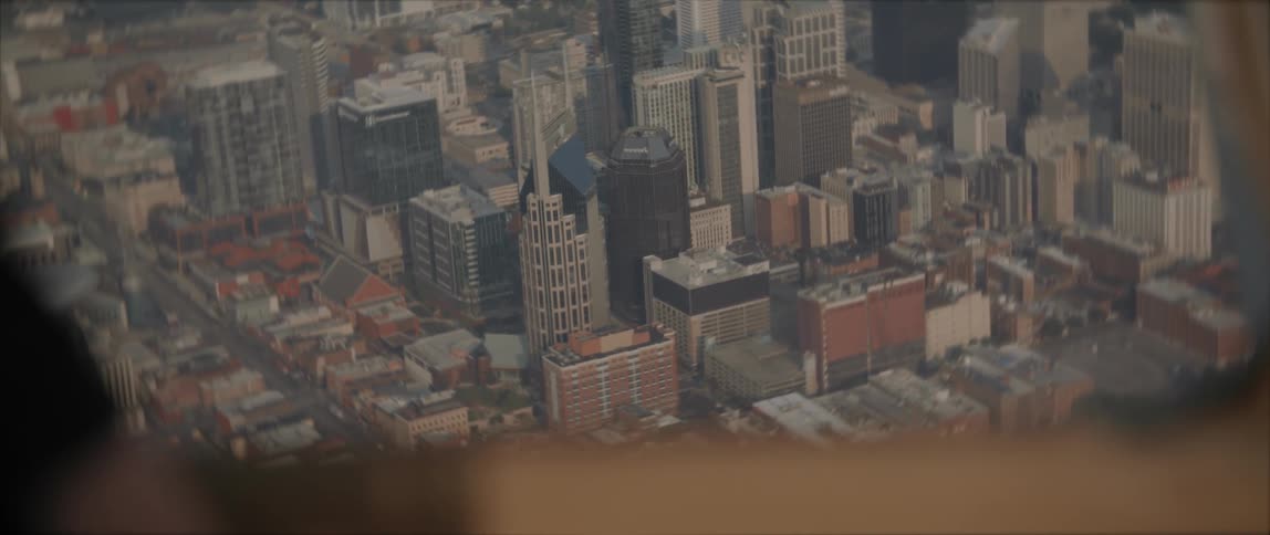 Airplane flies over the city buildings